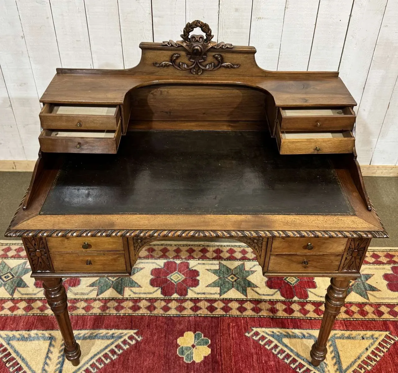 Louis XVI style desk from the late 19th century in walnut with a leather top.