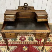 Louis XVI style desk from the late 19th century in walnut with a leather top.