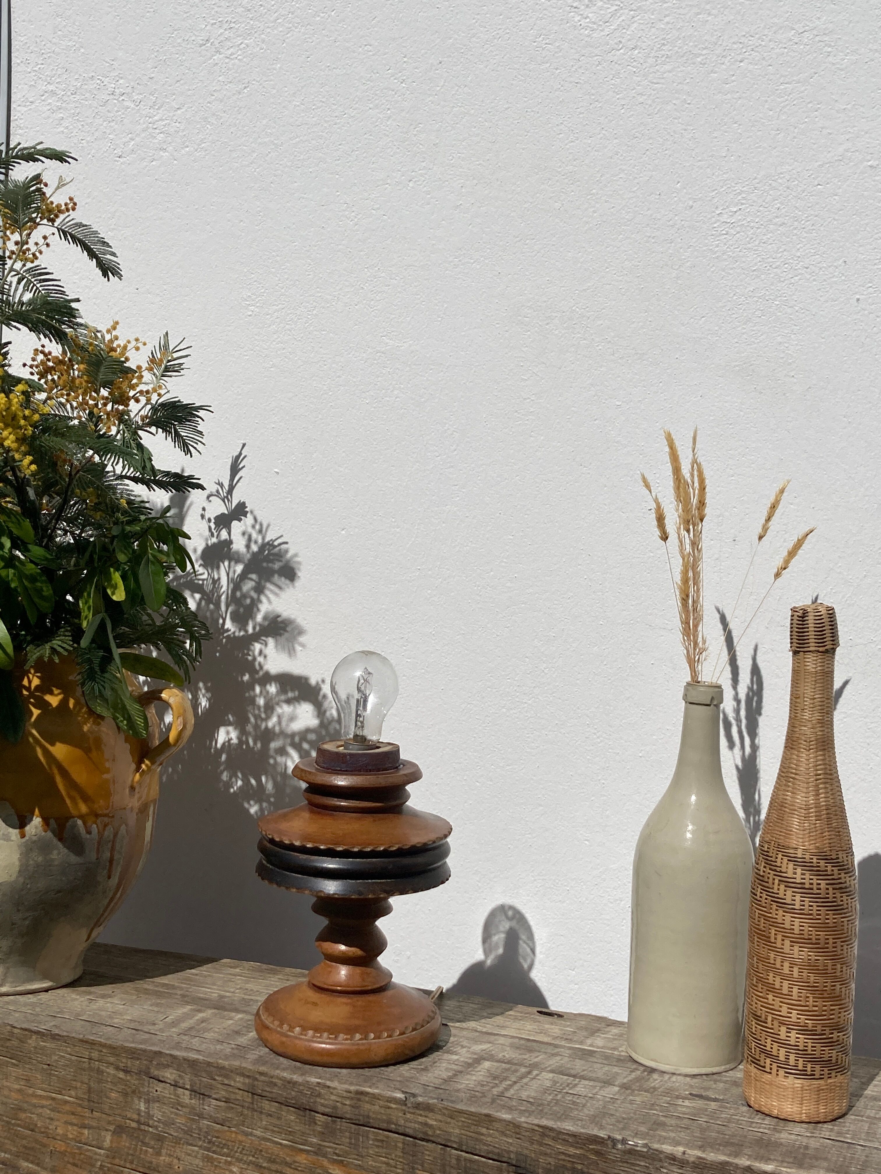 Foot of turned wooden lamp and carved