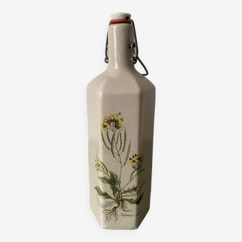 Faceted stoneware bottle signed La Cigogne, floral model (Diplotaxis muralis)