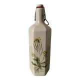 Faceted stoneware bottle signed La Cigogne, floral model (Diplotaxis muralis)