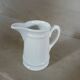 2 small white porcelain pitchers