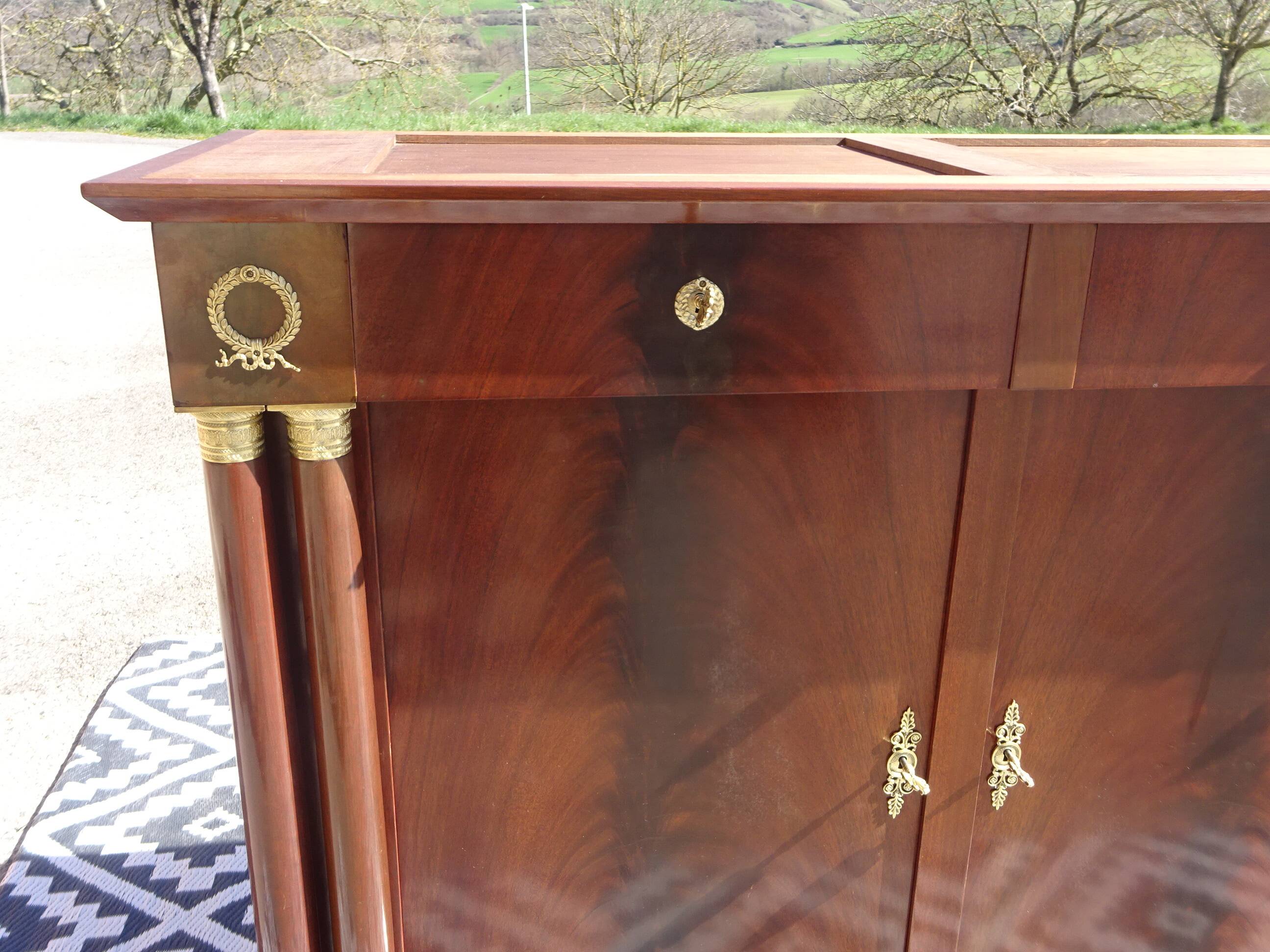 Flamed mahogany enfilade with sea green marble in Empire style.