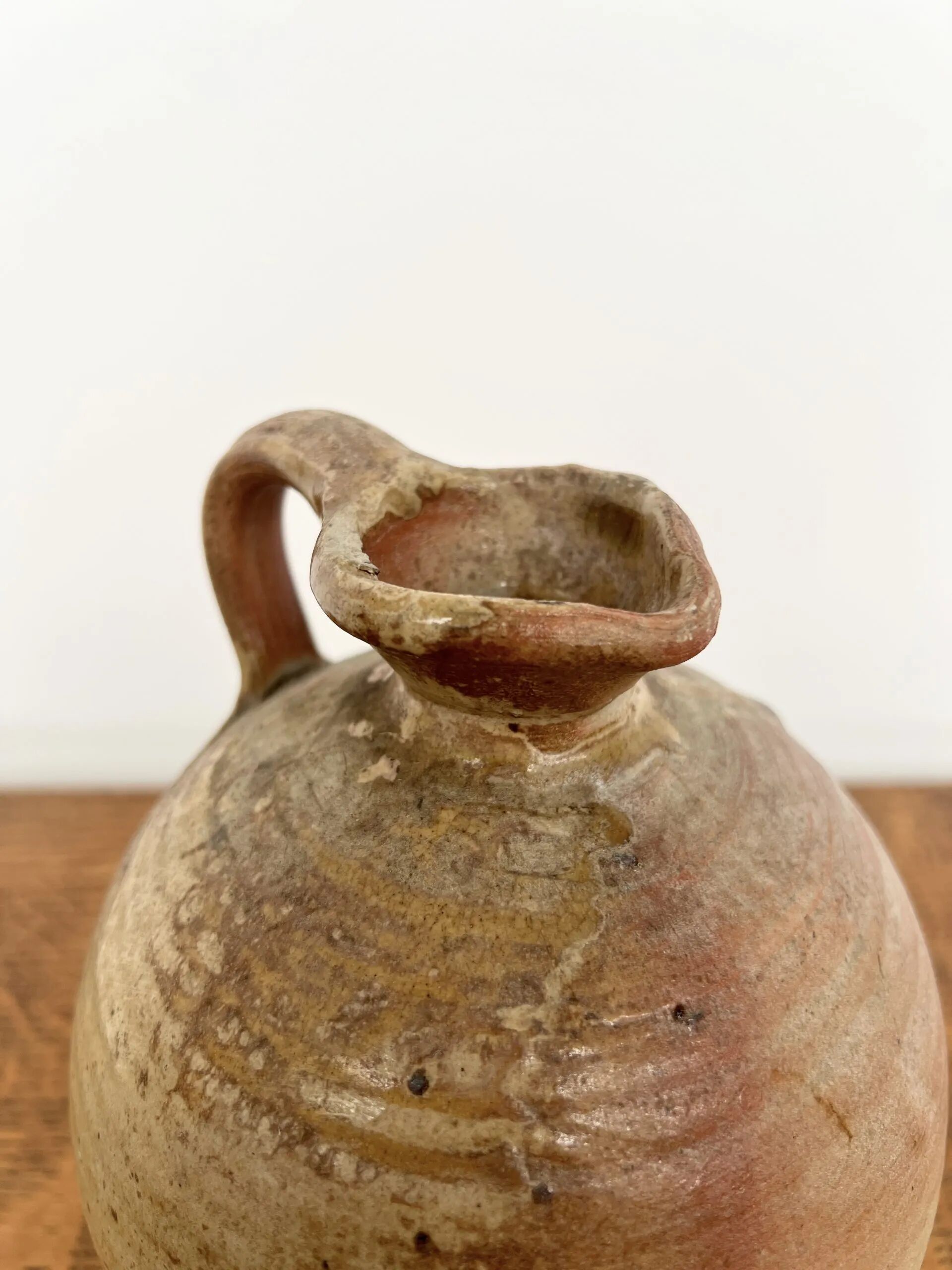 Small antique stoneware jar with handle