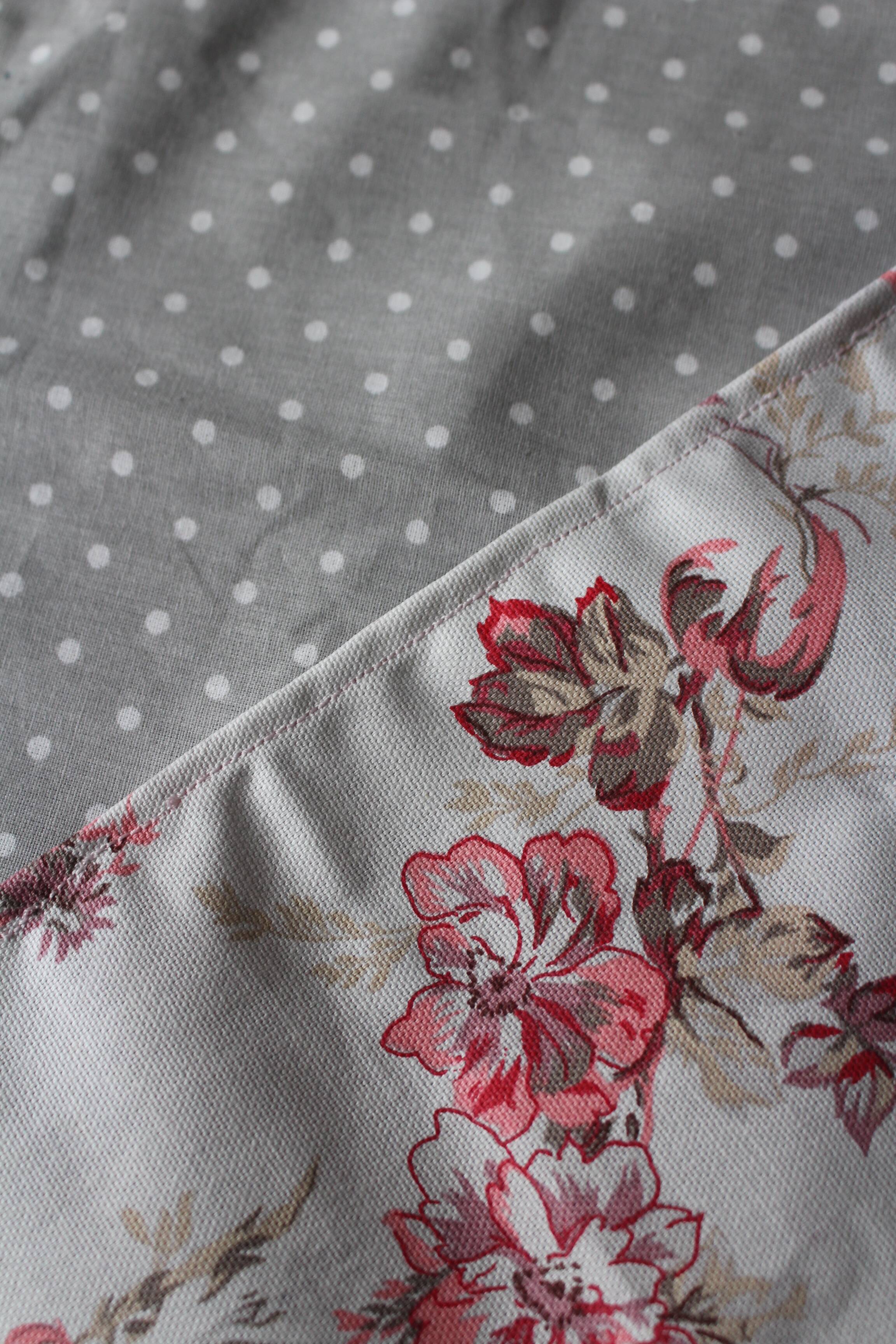 A set of 8 gray blue napkins with pink flowers and polka dots