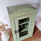 Small glass cabinet in green colour.