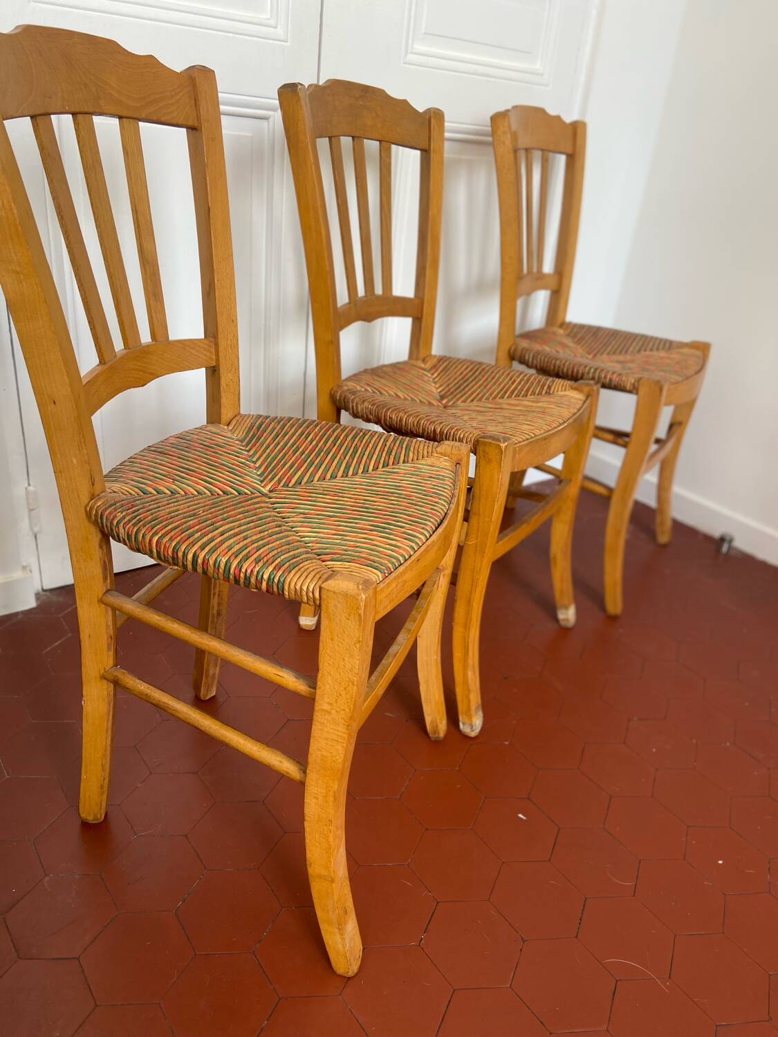 Trio of vintage straw/colored chairs