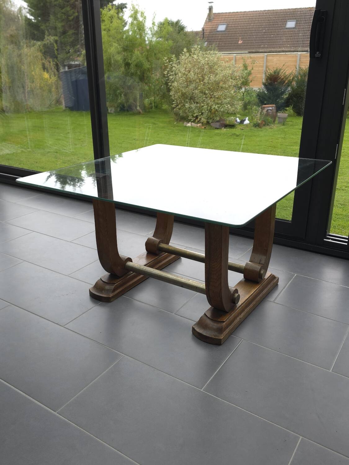 Art Deco coffee table in glass, wood, and brass.