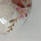 Red-orange glazed ceramic workshop bowl with floral decoration.