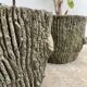 Two cement planters imitation tree trunks