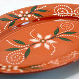 Portuguese XL dish in orange enamelled clay with unbleached flowers and green leaves