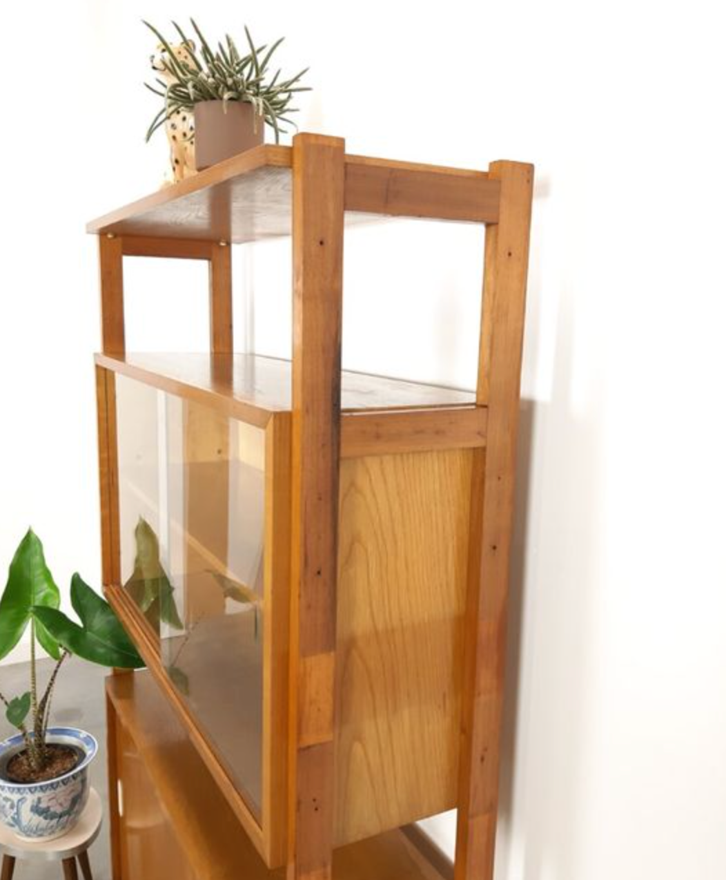 Vintage wooden showcase with sliding doors and white handles