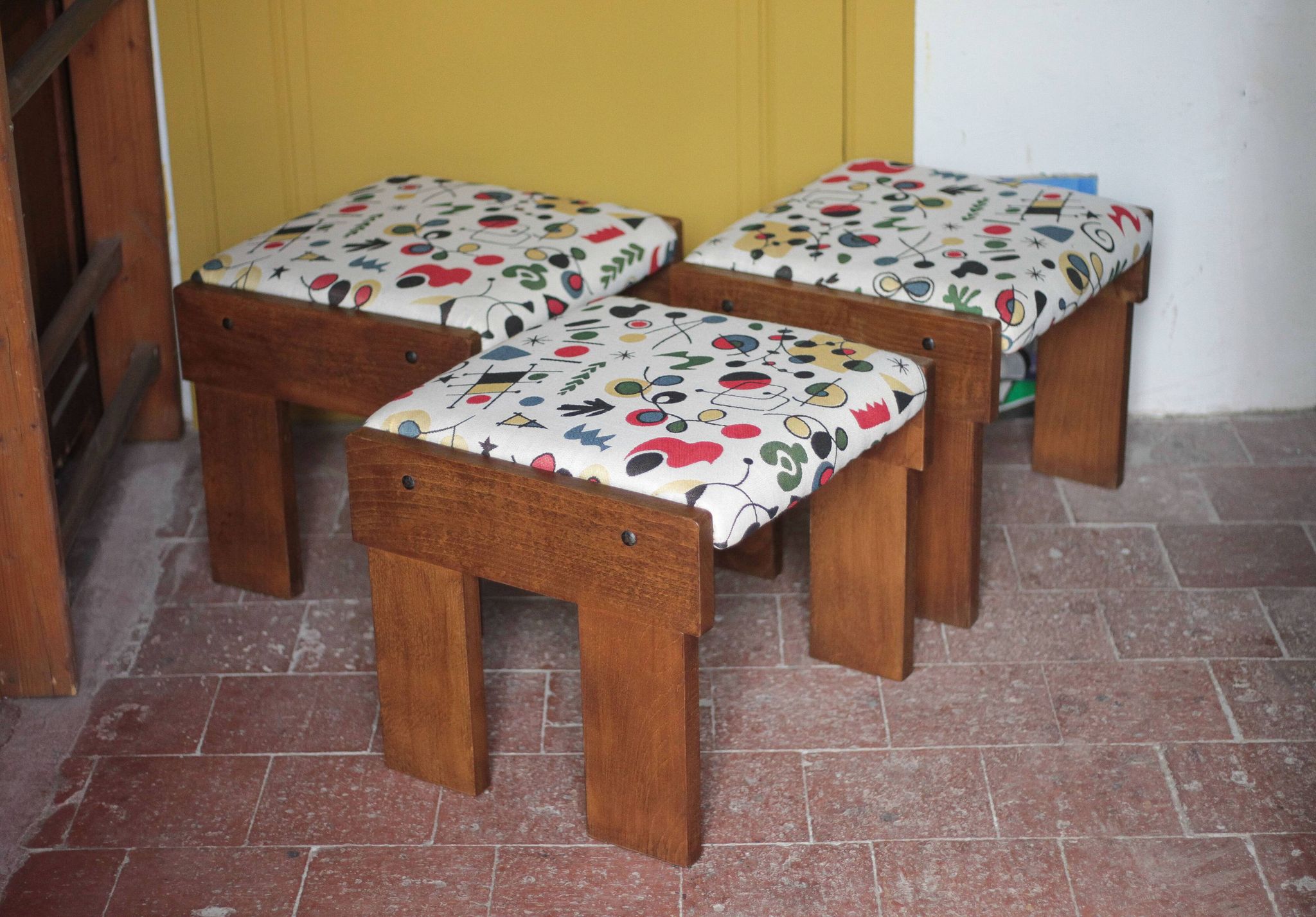 Set of 3 beech wood stools with fabric upholstery in the style of Miro.