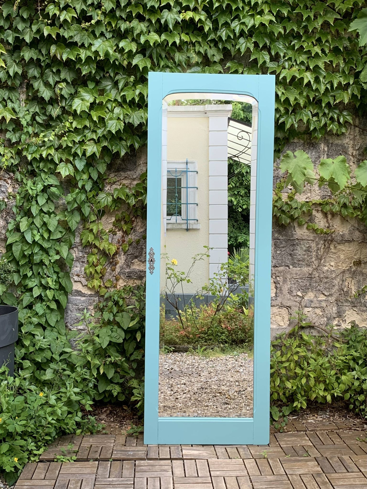 Beveled mirror on turquoise Parisian door