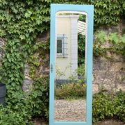 Beveled mirror on turquoise Parisian door