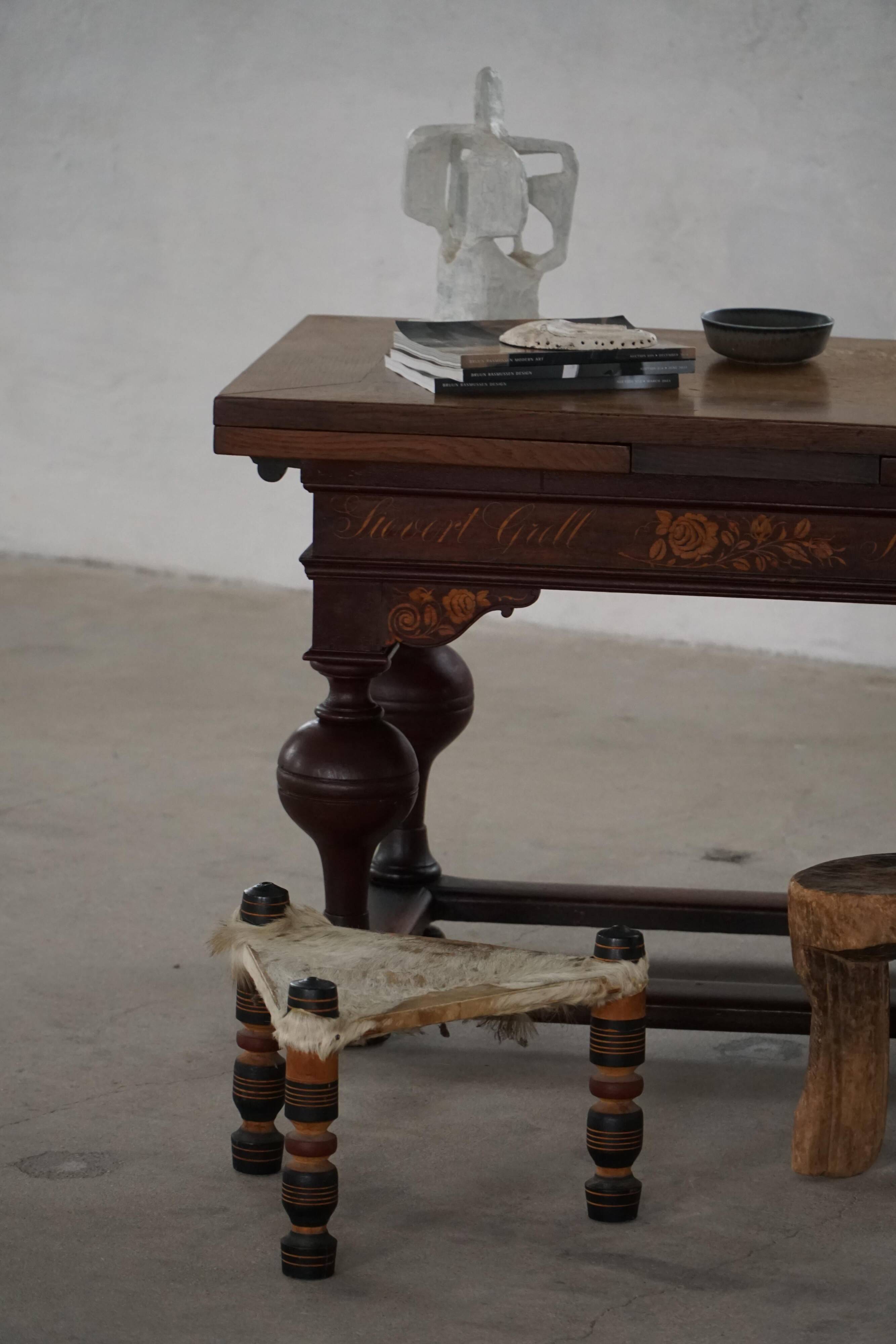 Vintage African artisanal stool, triangular shape with 3 legs, cowhide, 20th century.
