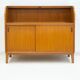 Modern Scandinavian wardrobe in teak with sliding doors and drop-down flap.