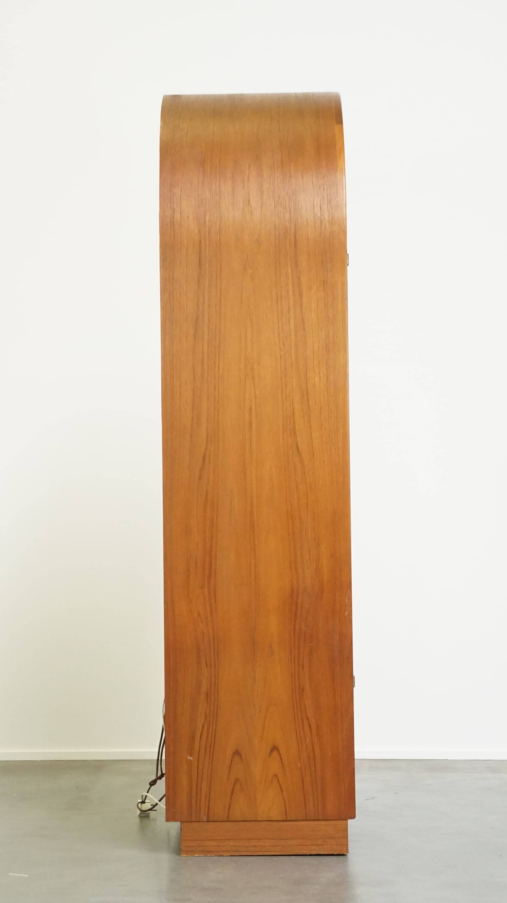 Elegant vintage Danish display cabinet with glass panels and atmospheric lighting