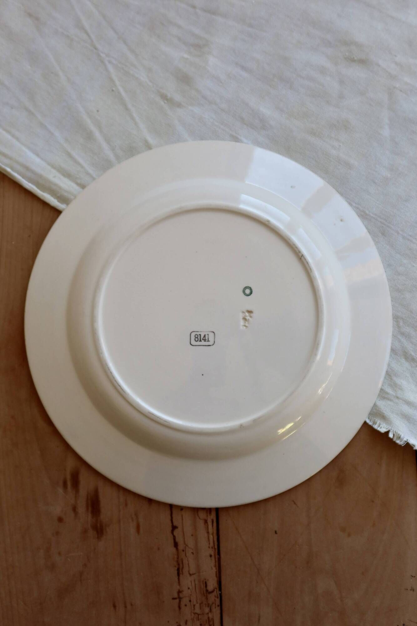 Round vintage ivory earthenware serving dish with double gold trim.