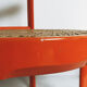 Chaise vintage en bois laqué orange et assise cannage