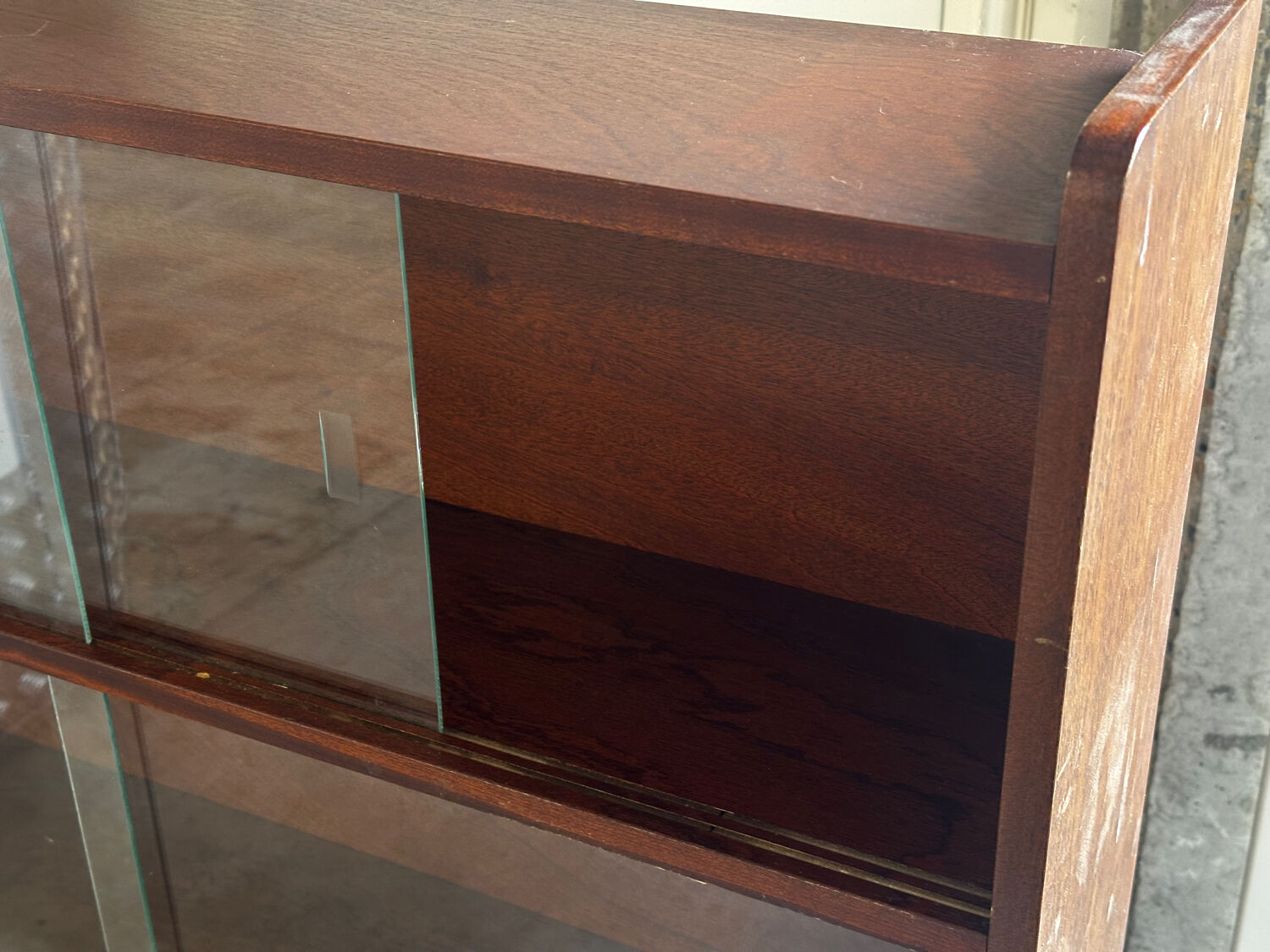 Vintage 1960s wooden library with sliding doors.