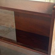 Vintage 1960s wooden library with sliding doors.