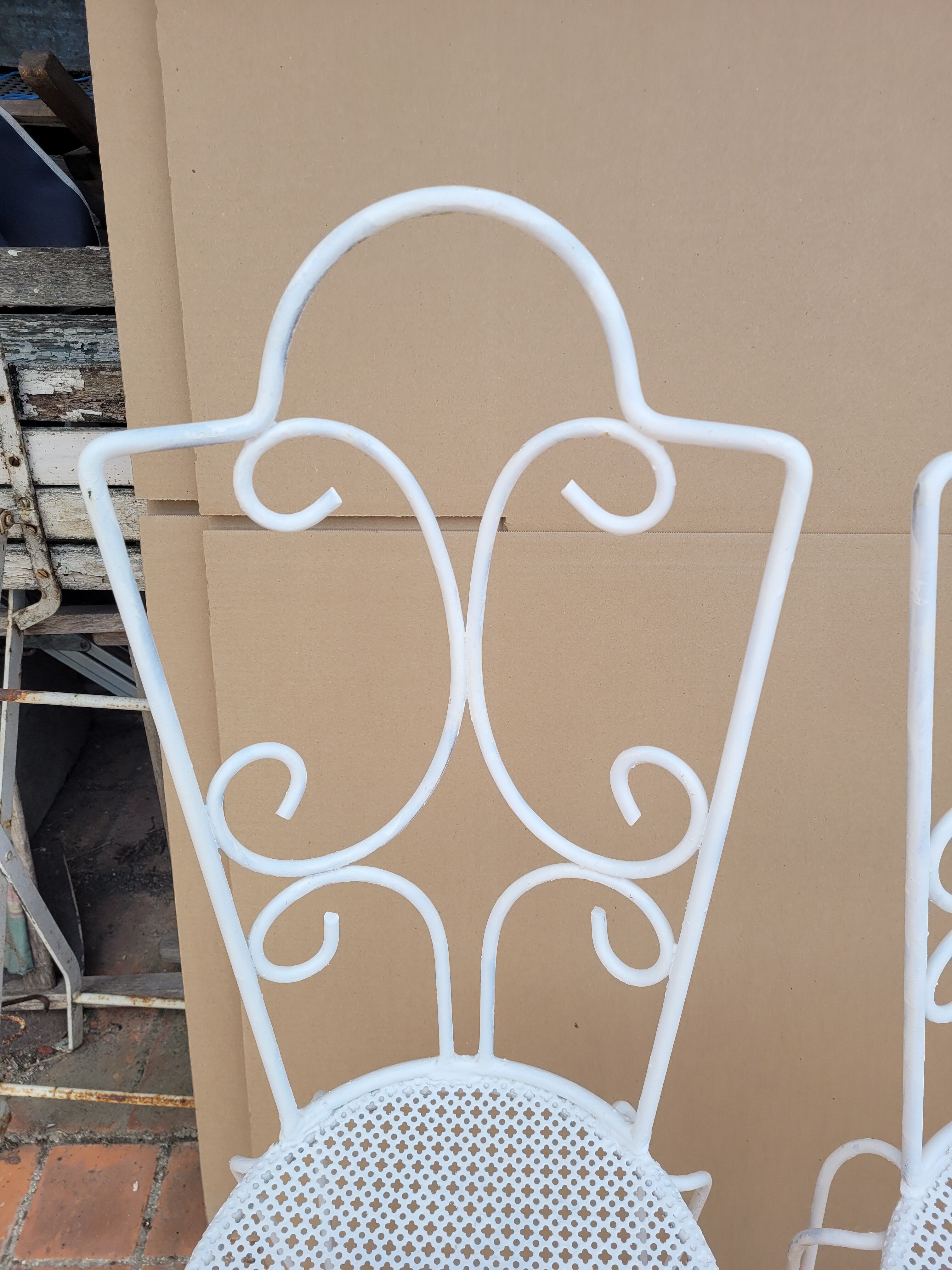 Pair of antique wrought iron garden chairs