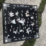 Chinese black lacquer side table with multicoloured inlays, 1950s.