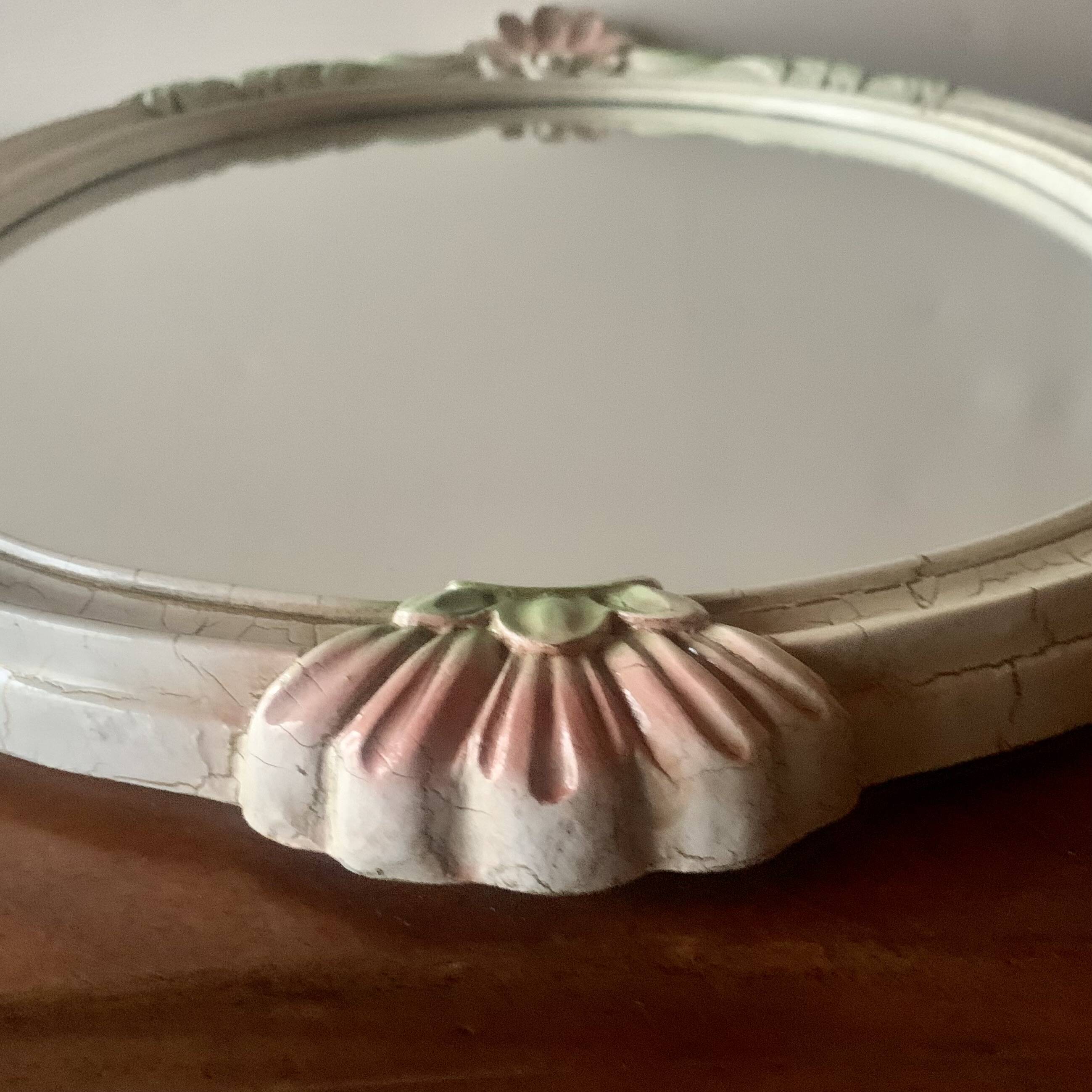 Vintage oval mirror in carved wood in pastel tones