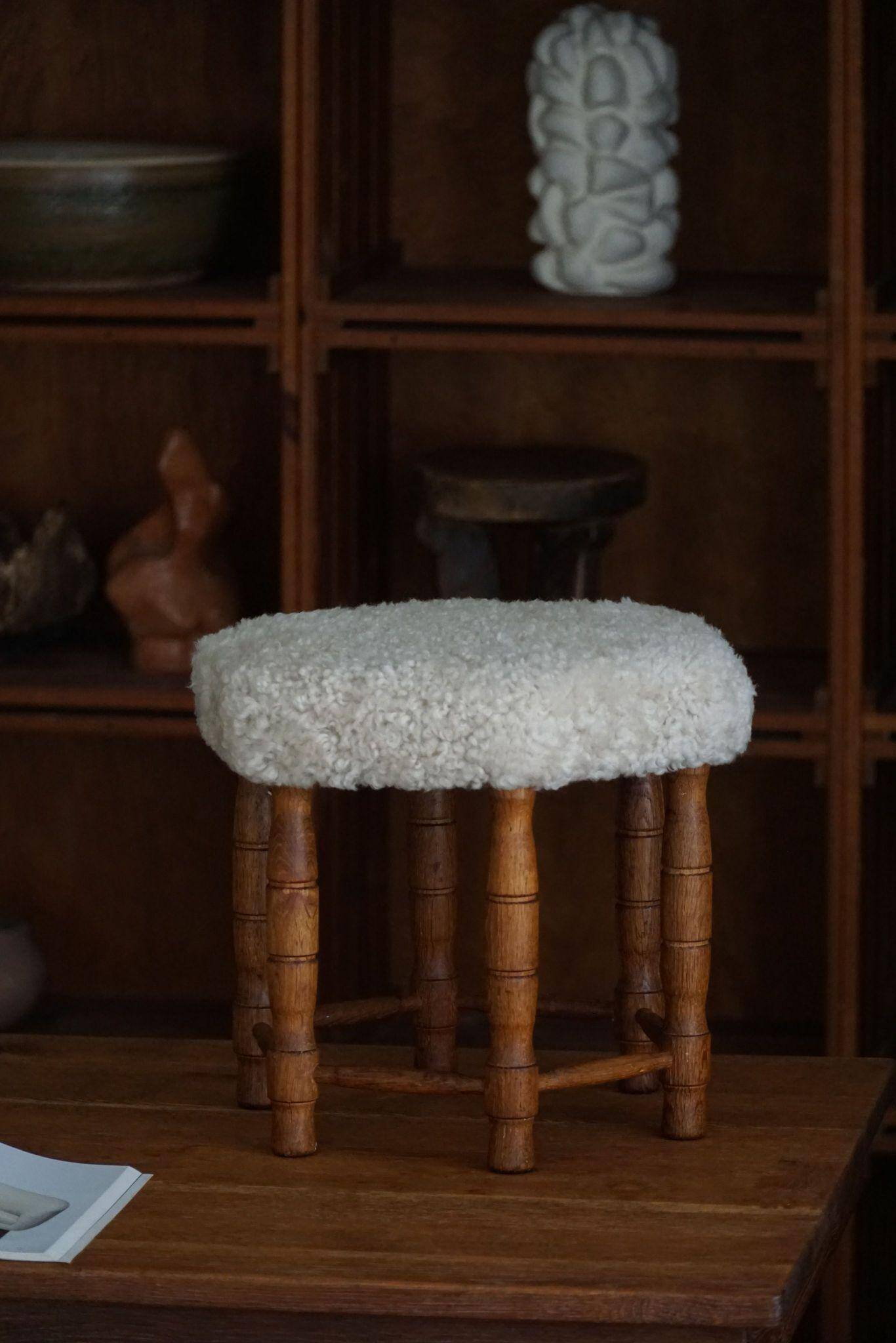 Modern Danish, a hexagonal oak stool, seat reupholstered in lambswool, 1950s.