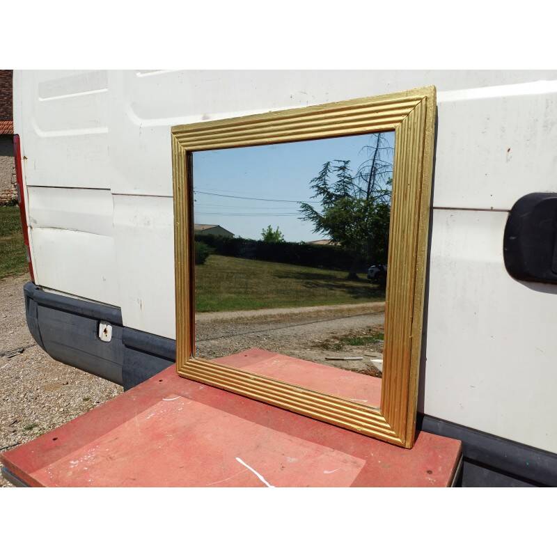 Wooden mirror and gold trim
