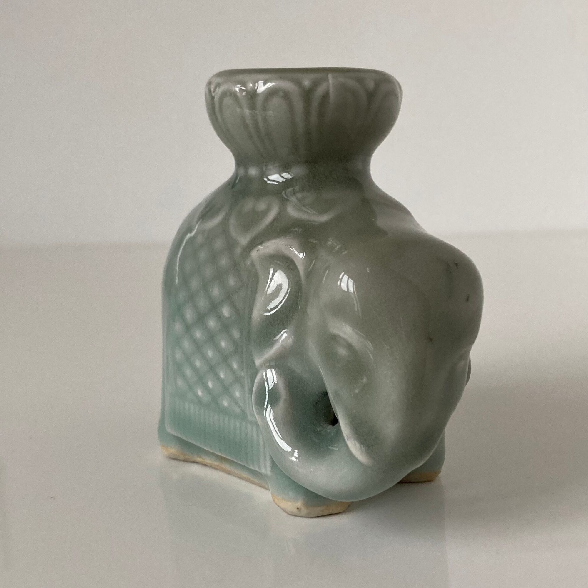 Porcelain candle holder and celadon cover in the shape of an elephant