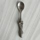 Antique small spoons with a metal bow design