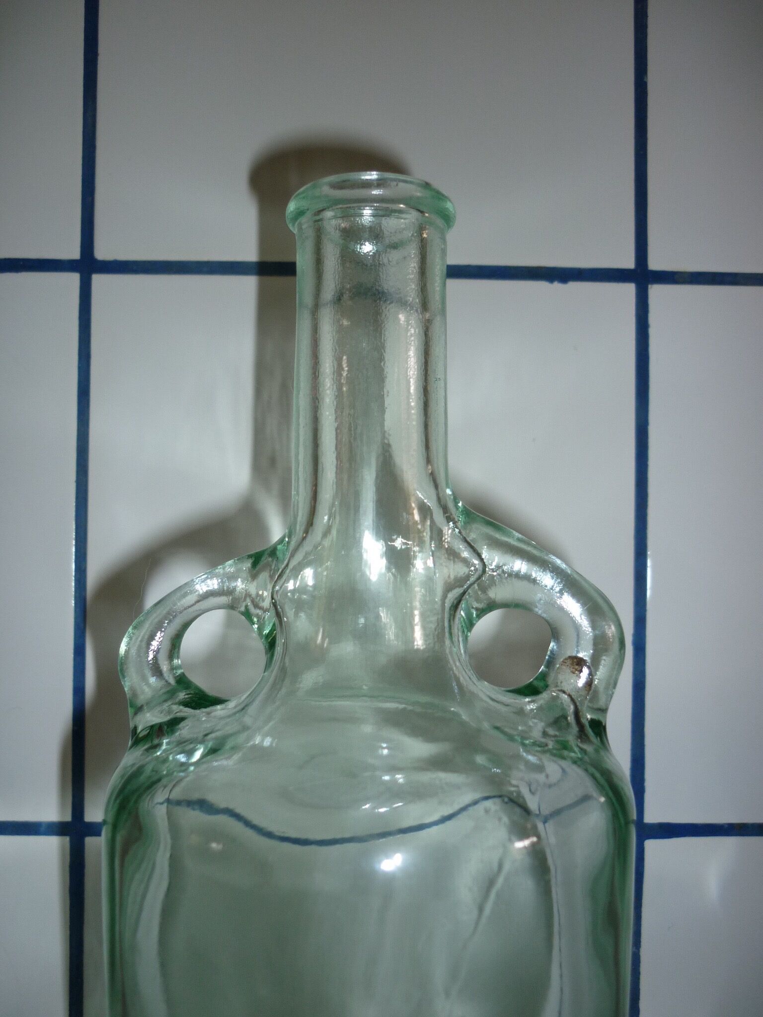 Old transparent moulded glass bottle