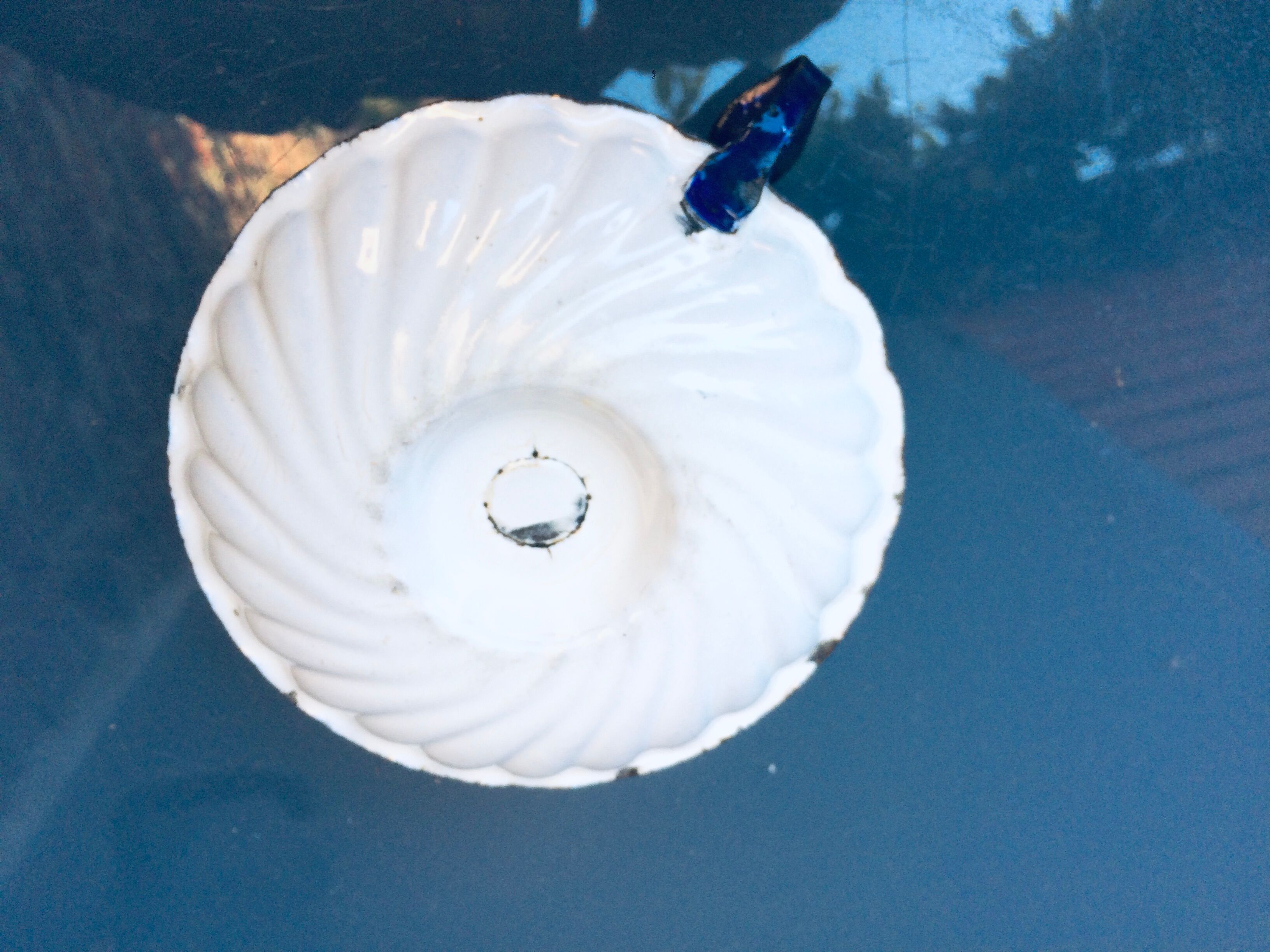 Old white enamelled candlestick