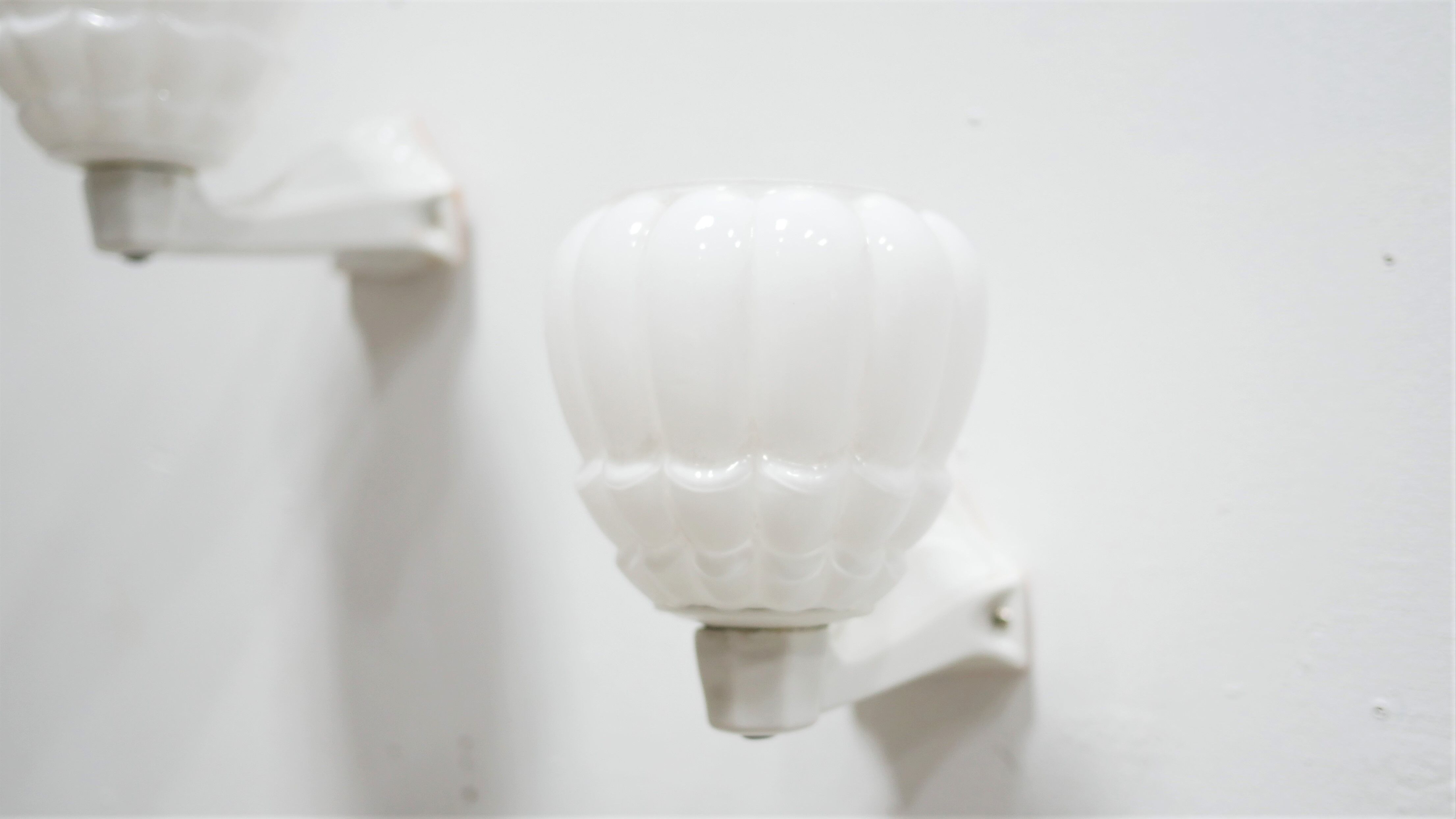 Pair of art deco porcelain and glass wall appliques