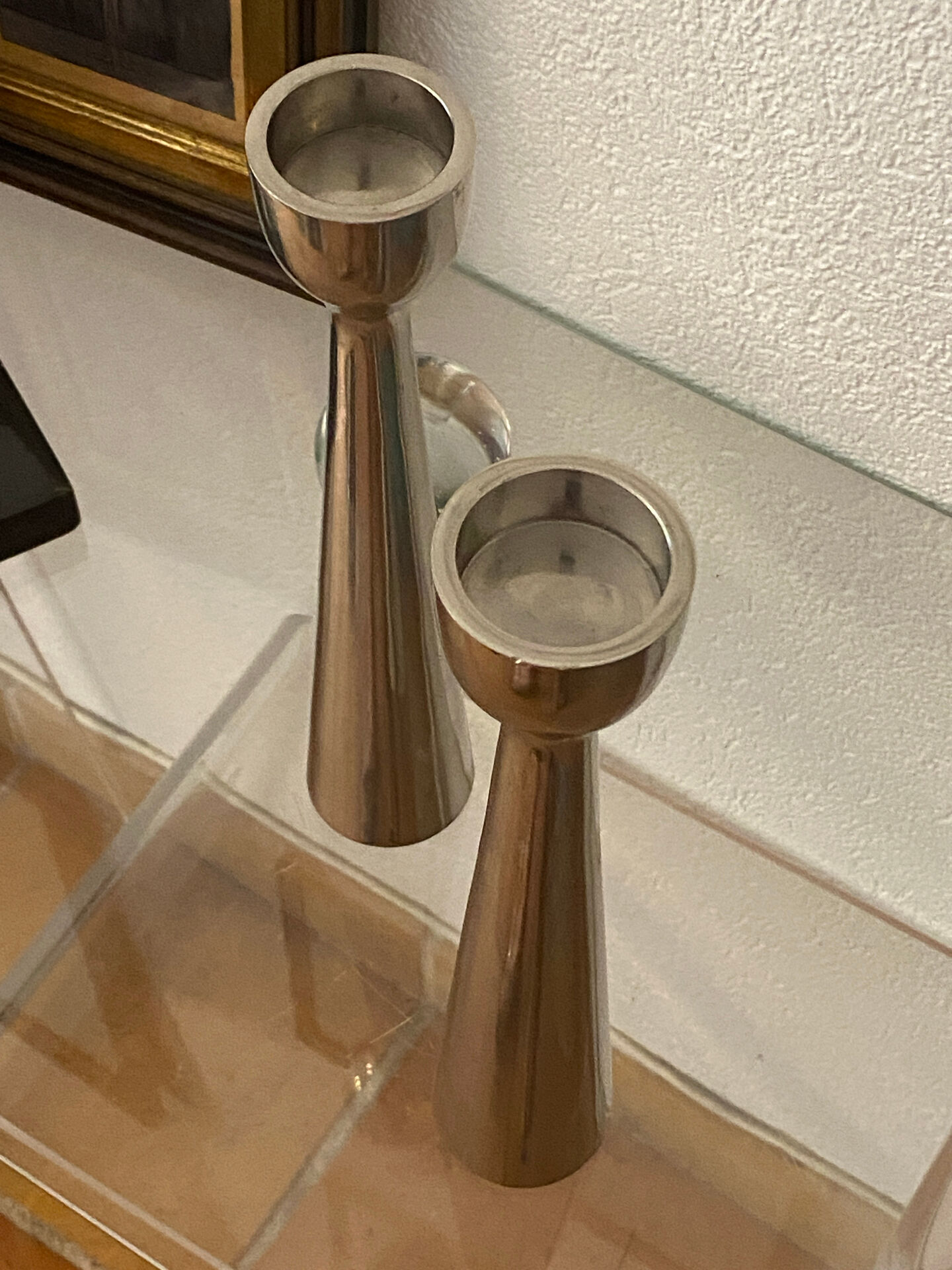Pair of polished aluminium candlesticks