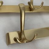 Three vintage 1960s gold coat racks 4, 3 and 2 hooks
