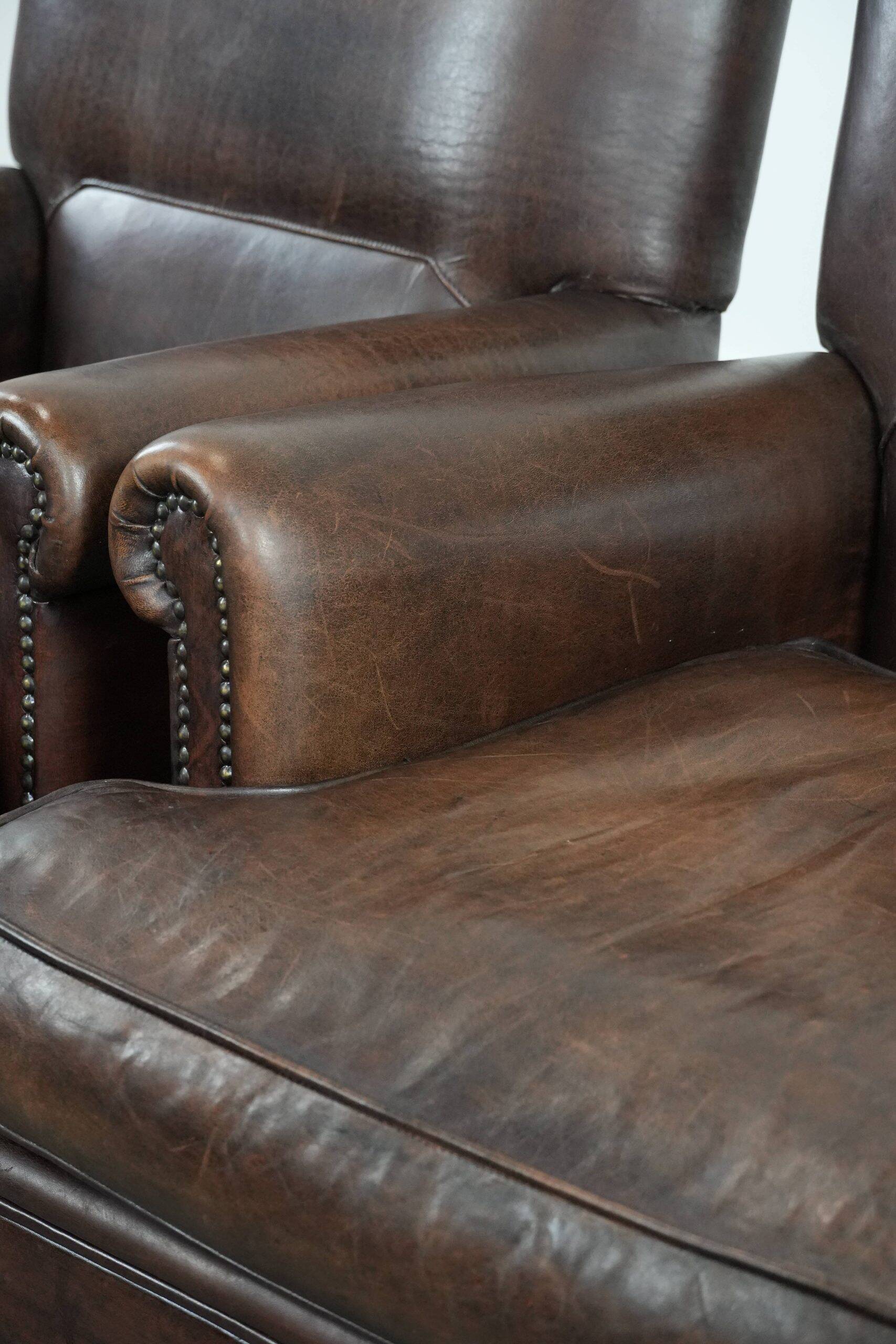 Set of two characterful sheepskin armchairs with a beautiful deep colour