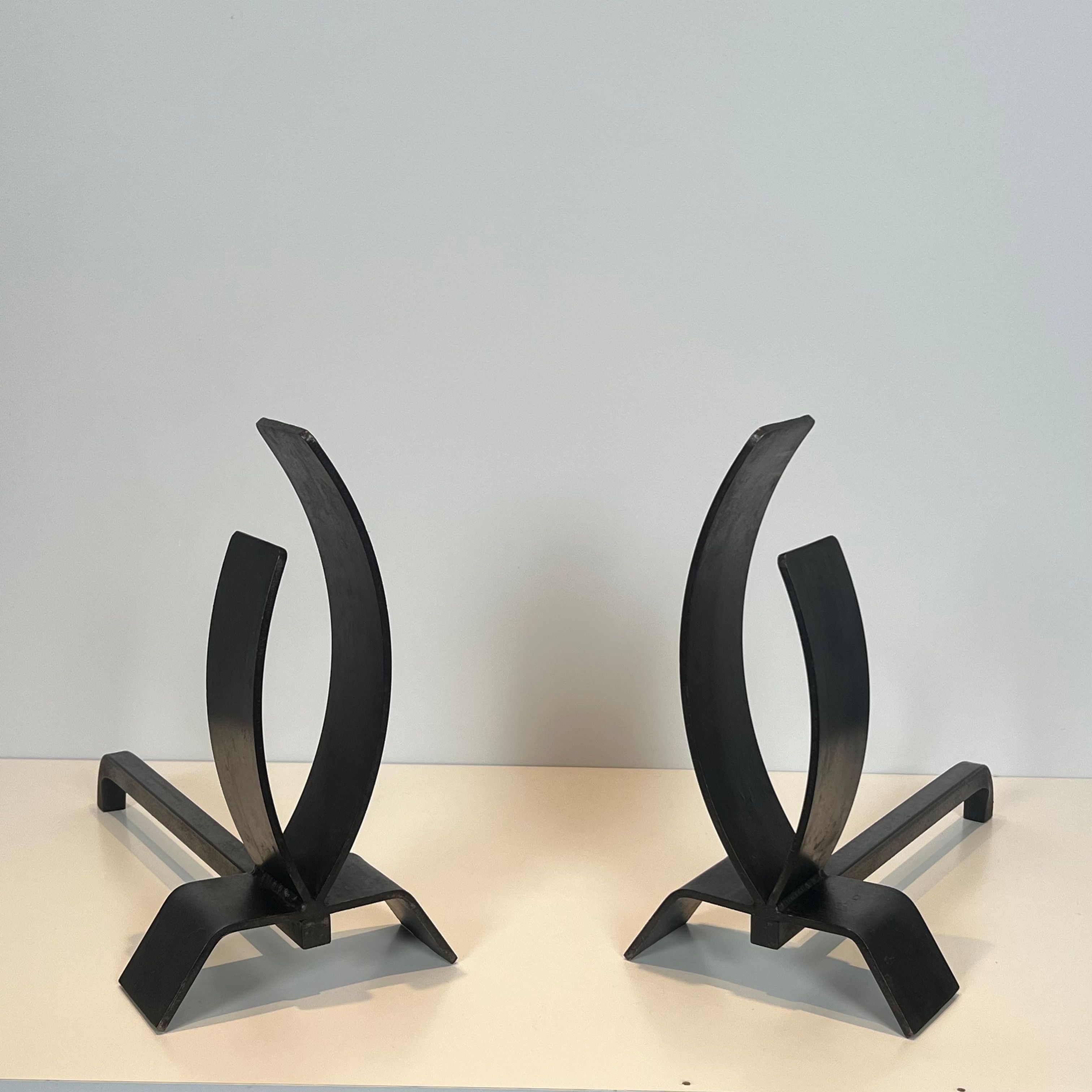 Pair of modernist andirons in steel and wrought iron