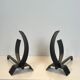 Pair of modernist andirons in steel and wrought iron