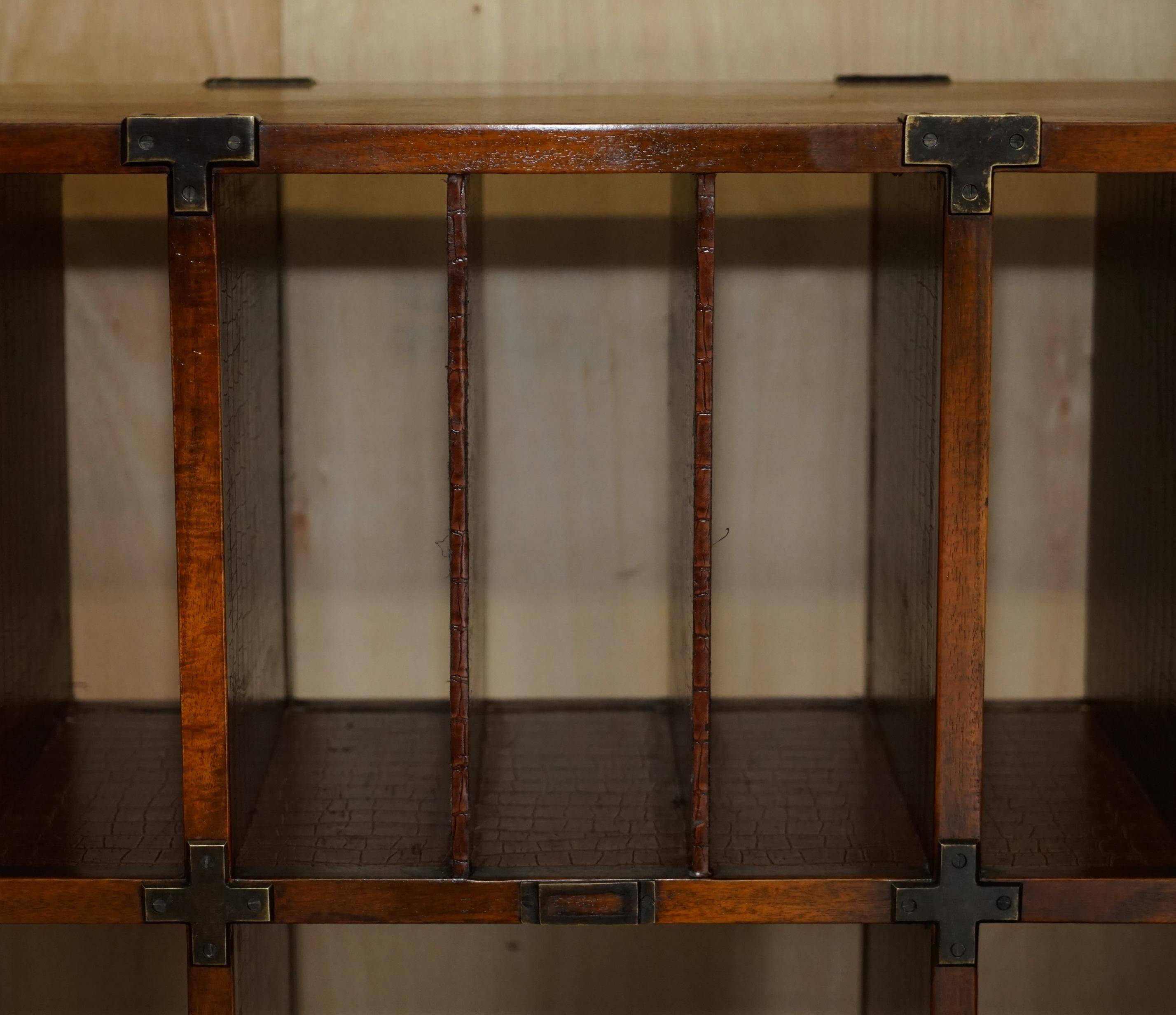 Pair of open bookshelves in crocodile leather with drawers and compartments.
