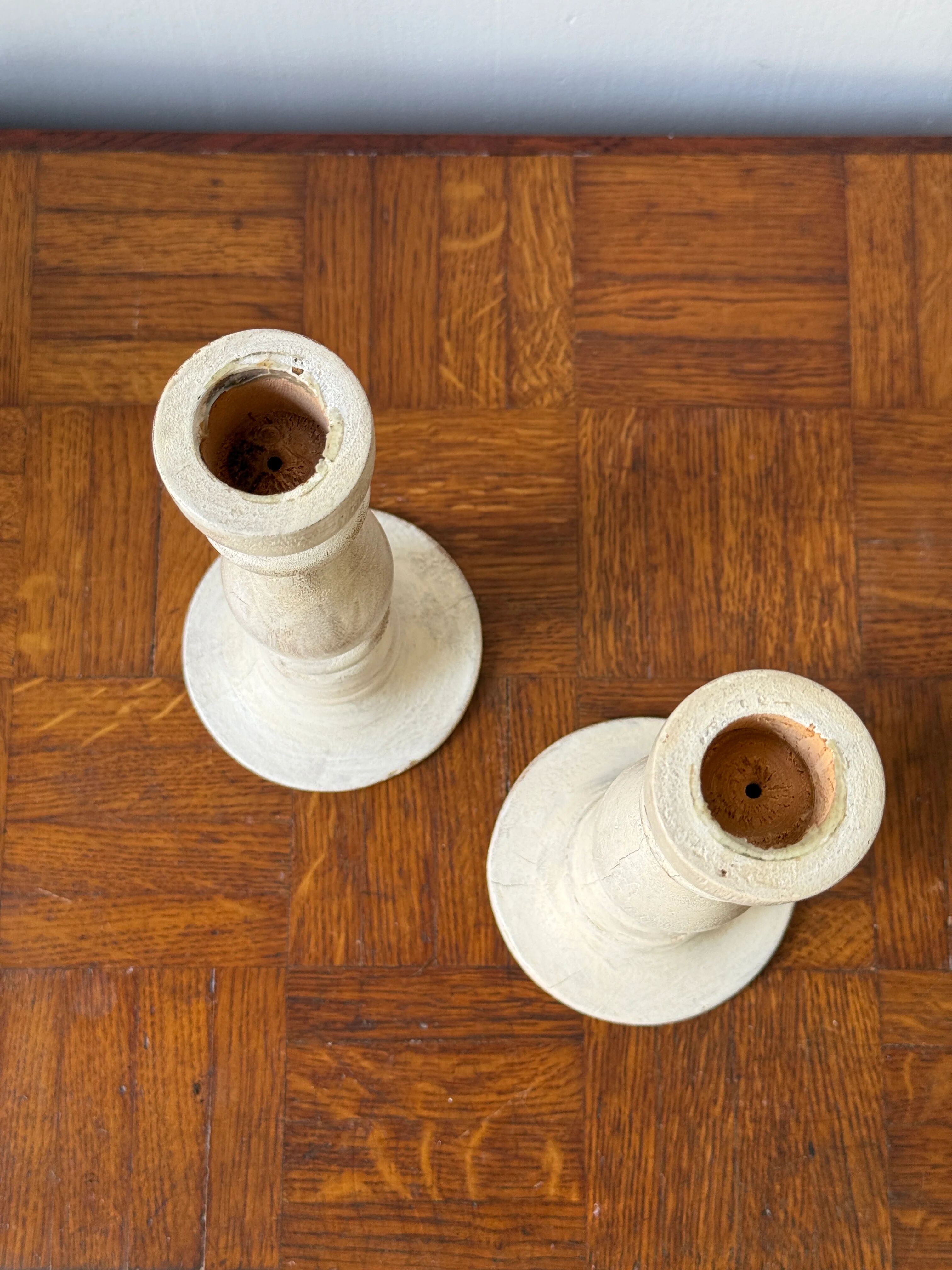 Pair of white wooden candlesticks
