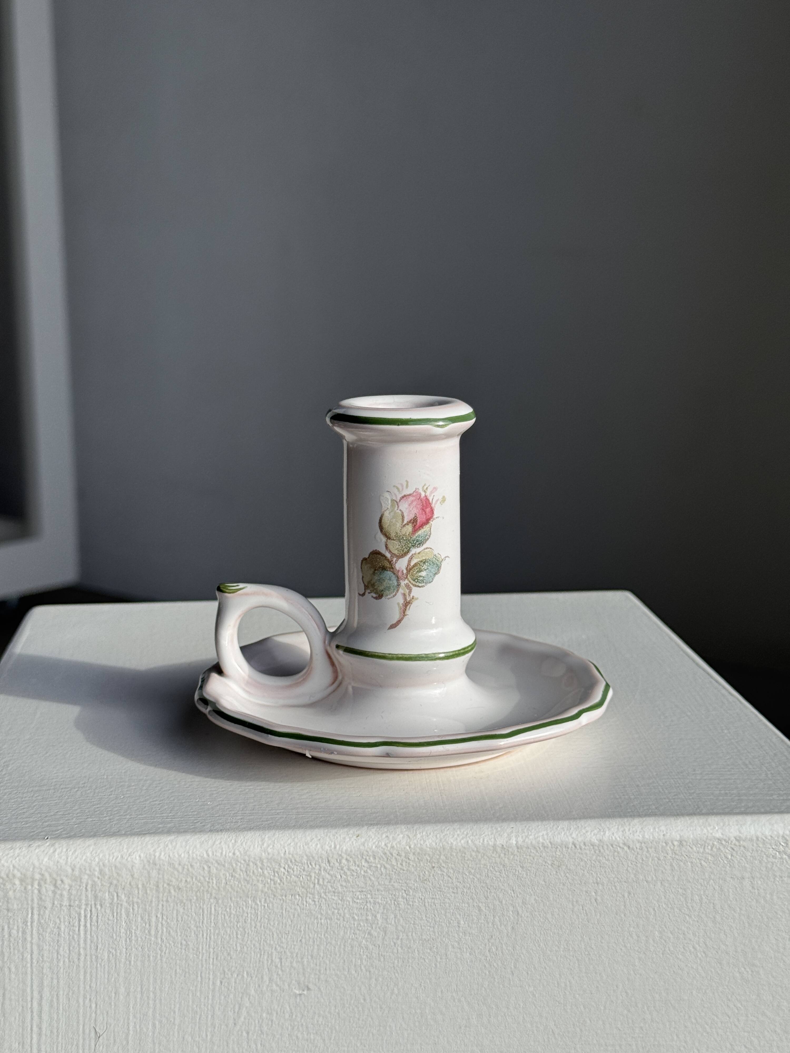 Small vintage hand-held candlestick in earthenware with green trim and floral decoration H10.5