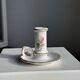 Small vintage hand-held candlestick in earthenware with green trim and floral decoration H10.5