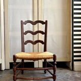 Low Provencal chair in dark wood and woven straw