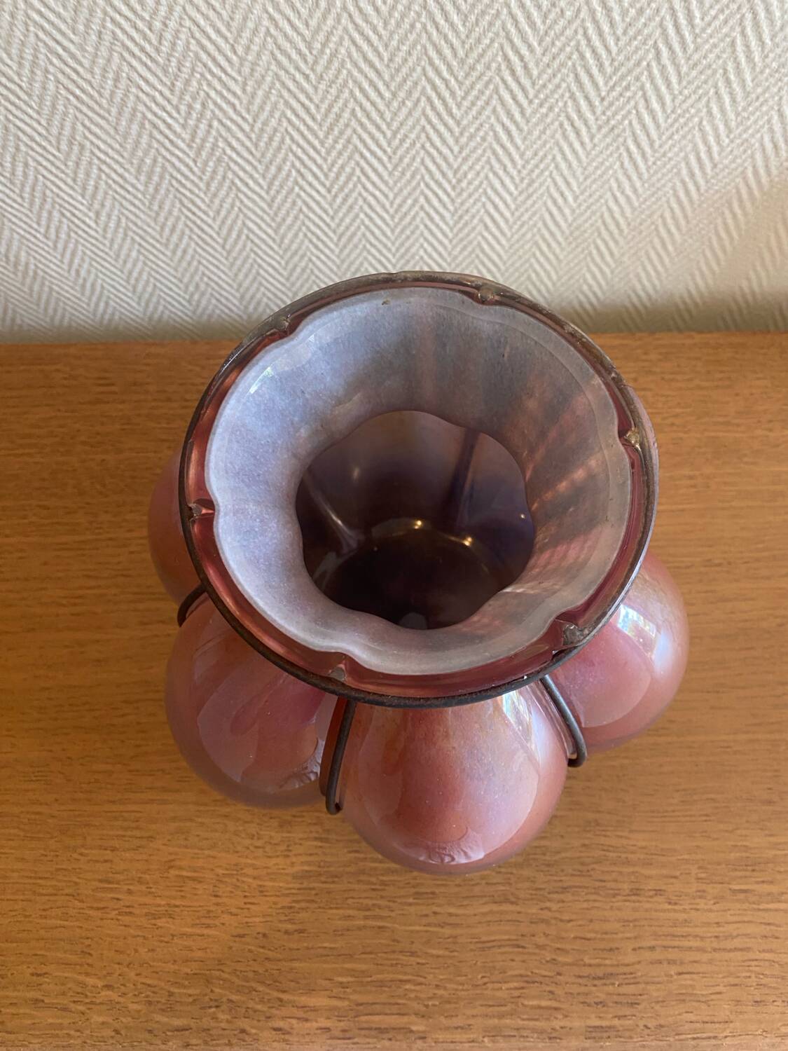 Blown glass vase with metal cage