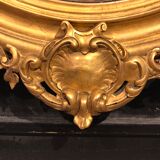 Golden oval mirror