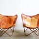Set of 2 vintage Butterfly chairs in brown leather with a metal frame.
