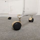 End of sofa with glass and plexiglass wheels from the 70s